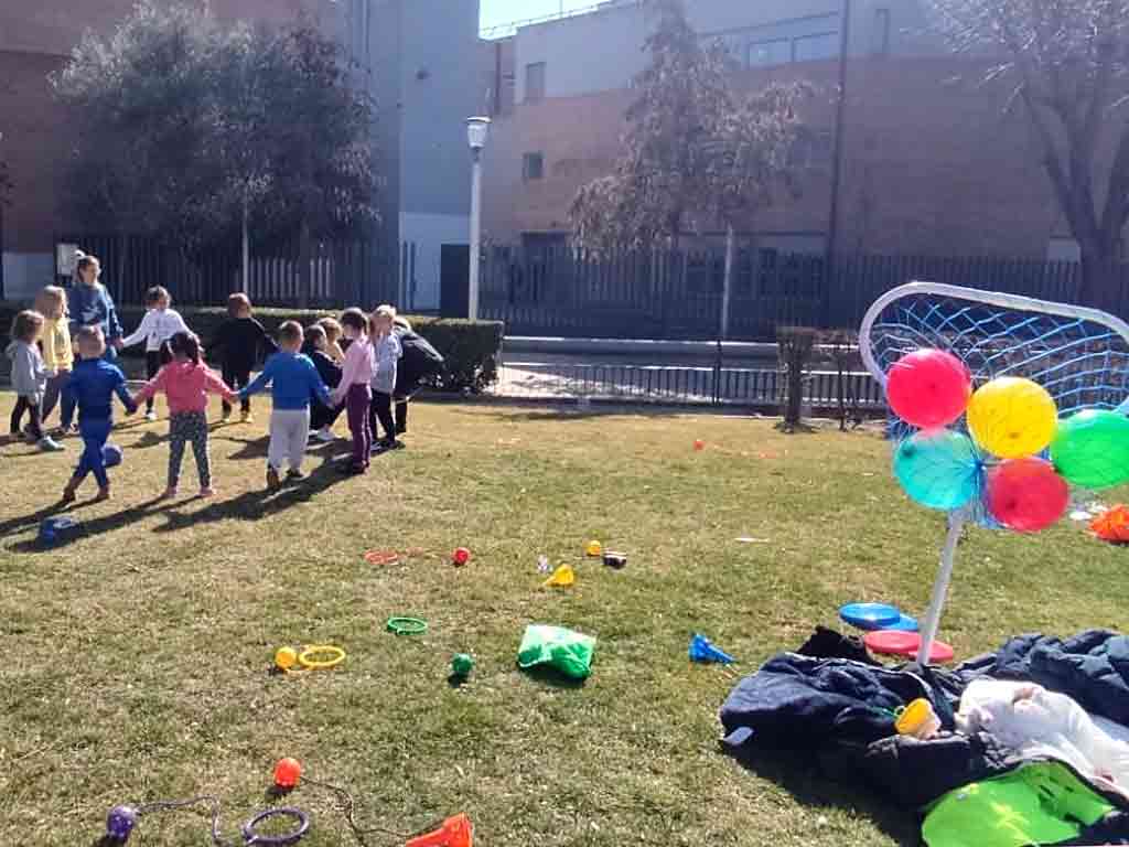 Varios niños hacen un corro durante una actividad al aire libre con Bill y Lula